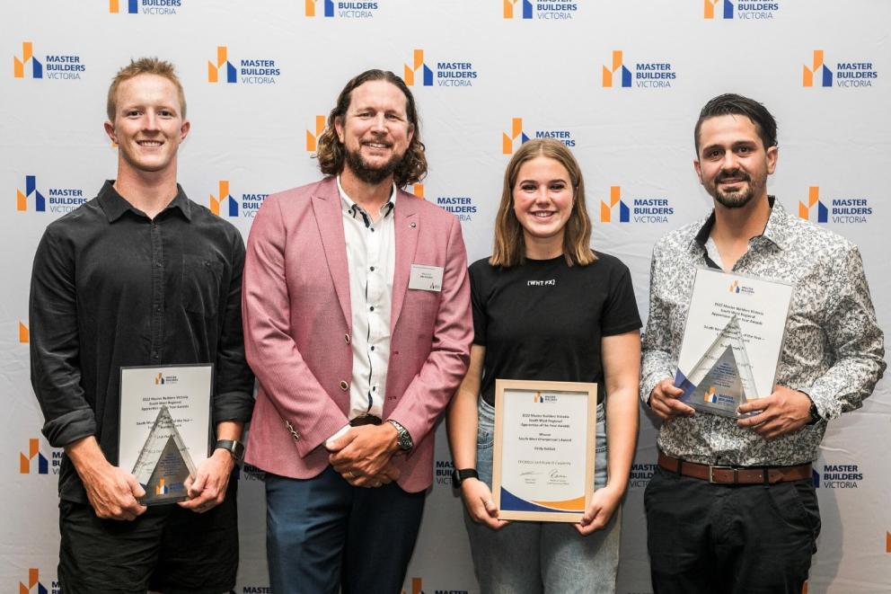 Jack and Emily posing with the presenter and third winner at the Master Builders Victoria Regional Apprentice of the Year Awards