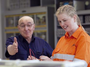 Jacinta Sapwell in high vis clothing with a teacher